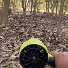 Cordless air duster moving loose dry leaves