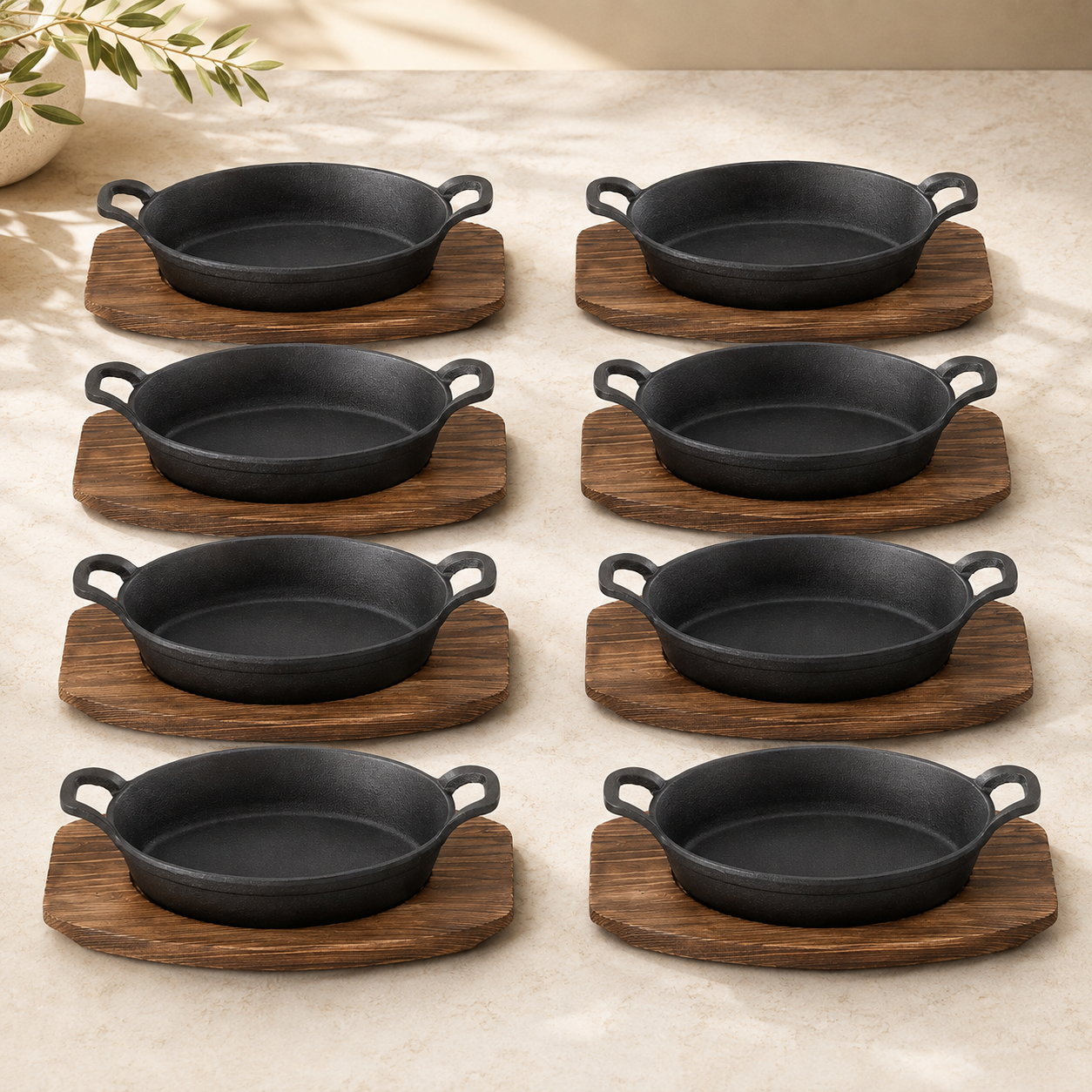 Eight complete cast iron pan and wood tray serving sets